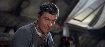 Movie still from “Chitty Chitty Bang Bang” (1968), directed by Ken Hughes – A person wearing a suit and tie; Close Up shot, Low angle