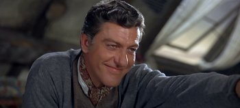 Movie still from “Chitty Chitty Bang Bang” (1968), directed by Ken Hughes – A person wearing a suit and tie; Close Up shot, Low angle