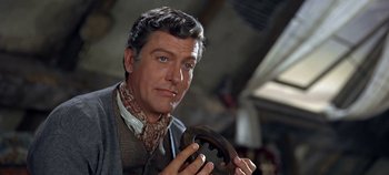 Movie still from “Chitty Chitty Bang Bang” (1968), directed by Ken Hughes – A person holding a steering wheel; Close Up shot, Low angle