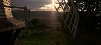 Movie still from “Chitty Chitty Bang Bang” (1968), directed by Ken Hughes – A person standing on top of a grass covered field; Extreme Wide shot, Low angle