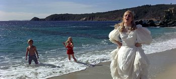 Movie still from “Chitty Chitty Bang Bang” (1968), directed by Ken Hughes – Two young girls on the beach playing in the water; Wide shot, Low angle