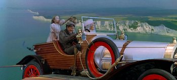 Movie still from “Chitty Chitty Bang Bang” (1968), directed by Ken Hughes – A man and two children in a car; Wide shot, High angle