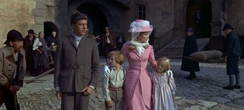 Movie still from “Chitty Chitty Bang Bang” (1968), directed by Ken Hughes – An older man and woman with two young children; Medium shot, Low angle
