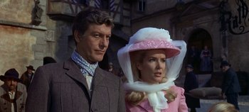 Movie still from “Chitty Chitty Bang Bang” (1968), directed by Ken Hughes – A man and a woman standing next to each other; Medium shot, Low angle