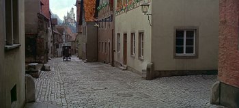 Movie still from “Chitty Chitty Bang Bang” (1968), directed by Ken Hughes – An empty street in the middle of a city; Extreme Wide shot, High angle