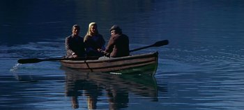 Movie still from “Chitty Chitty Bang Bang” (1968), directed by Ken Hughes – A group of people in a boat on a body of water; Wide shot, High angle