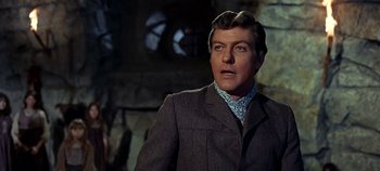 Movie still from “Chitty Chitty Bang Bang” (1968), directed by Ken Hughes – A person wearing a suit and tie; Close Up shot, Low angle