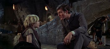 Movie still from “Chitty Chitty Bang Bang” (1968), directed by Ken Hughes – Two young men are sitting next to each other; Medium shot, Over the shoulder angle