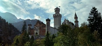 Movie still from “Chitty Chitty Bang Bang” (1968), directed by Ken Hughes – A large castle with a tower on top of it; Extreme Wide shot, Low angle