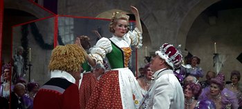 Movie still from “Chitty Chitty Bang Bang” (1968), directed by Ken Hughes – A group of people dressed up in costumes; Medium shot, Low angle