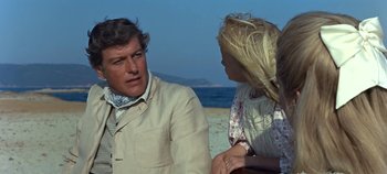 Movie still from “Chitty Chitty Bang Bang” (1968), directed by Ken Hughes – A man and a woman on the beach talking to each other; Medium shot, Over the shoulder angle