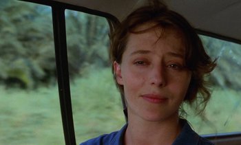 Movie still from “Chocolat” (1988), directed by Claire Denis – A person in a car; Close Up shot, Over the shoulder angle