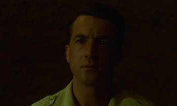 Movie still from “Chocolat” (1988), directed by Claire Denis – A person wearing a yellow shirt; Close Up shot, Low angle