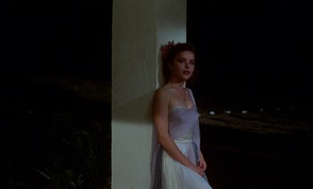 Movie still from “Chocolat” (1988), directed by Claire Denis – A beautiful young lady wearing a long white dress; Medium shot, Low angle