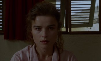Movie still from “Chocolat” (1988), directed by Claire Denis – A young woman is looking into the camera; Close Up shot, High angle