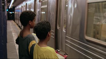 Movie still from “Chop Shop” (2007), directed by Ramin Bahrani – Two young boys standing in front of a subway train; Medium shot, Over the shoulder angle