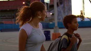 Movie still from “Chop Shop” (2007), directed by Ramin Bahrani – A woman with a ponytail and a man with a backpack; Medium shot, Low angle