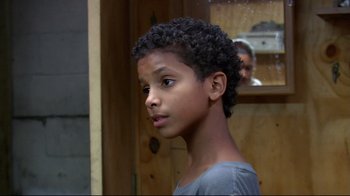 Movie still from “Chop Shop” (2007), directed by Ramin Bahrani – A young boy is looking into the distance; Close Up shot, Over the shoulder angle