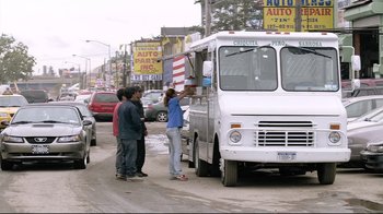 Movie still from “Chop Shop” (2007), directed by Ramin Bahrani – Three people standing on the side of the road near an ice cream truck; Wide shot, Low angle