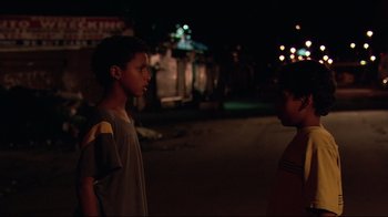 Movie still from “Chop Shop” (2007), directed by Ramin Bahrani – Two young boys standing in the street at night; Medium shot, Over the shoulder angle
