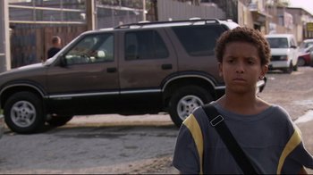Movie still from “Chop Shop” (2007), directed by Ramin Bahrani – A young man standing on the side of the street; Close Up shot, Low angle