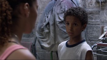 Movie still from “Chop Shop” (2007), directed by Ramin Bahrani – A young boy standing in front of another young person; Close Up shot, Over the shoulder angle