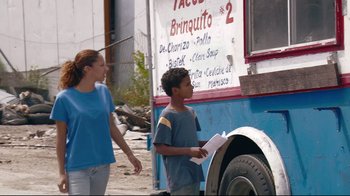 Movie still from “Chop Shop” (2007), directed by Ramin Bahrani – A woman and a boy standing in front of a food truck; Medium shot, Over the shoulder angle
