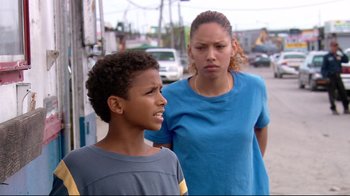Movie still from “Chop Shop” (2007), directed by Ramin Bahrani – A woman and a boy standing next to each other on the street; Close Up shot, Over the shoulder angle