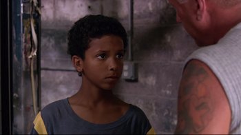 Movie still from “Chop Shop” (2007), directed by Ramin Bahrani – A young boy is looking at a man; Close Up shot, Over the shoulder angle