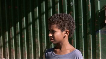 Movie still from “Chop Shop” (2007), directed by Ramin Bahrani – A young boy is looking to his left; Close Up shot, Over the shoulder angle