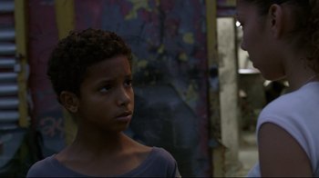 Movie still from “Chop Shop” (2007), directed by Ramin Bahrani – A young boy looking at another young man; Close Up shot, Over the shoulder angle