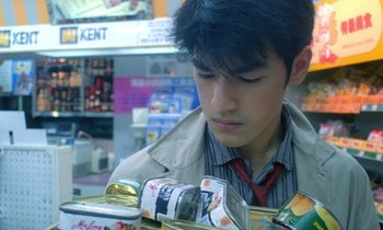 Movie still from “Chungking Express” (1994), directed by Kar-Wai Wong – A young man looking at cans in a grocery store; Close Up shot, Low angle