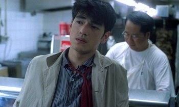 Movie still from “Chungking Express” (1994), directed by Kar-Wai Wong – A young man in a jacket and a red tie; Close Up shot, Over the shoulder angle