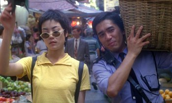 Movie still from “Chungking Express” (1994), directed by Kar-Wai Wong – A man and a woman standing next to each other on the street; Medium shot, Low angle