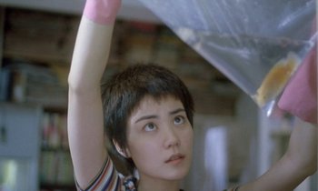 Movie still from “Chungking Express” (1994), directed by Kar-Wai Wong – A woman with a pink glove on her arm; Close Up shot, Low angle