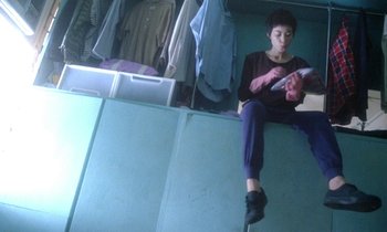 Movie still from “Chungking Express” (1994), directed by Kar-Wai Wong – A woman sitting on the floor of a room; Medium shot, Low angle