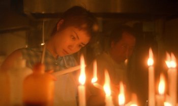 Movie still from “Chungking Express” (1994), directed by Kar-Wai Wong – A man and a woman lighting candles in front of a mirror; Close Up shot, Low angle