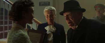 Movie still from “Churchill” (2017), directed by Jonathan Teplitzky – A group of people standing next to each other in a room; Medium shot, Over the shoulder angle