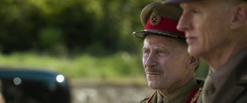 Movie still from “Churchill” (2017), directed by Jonathan Teplitzky – An older man wearing a uniform and a hat; Close Up shot, Over the shoulder angle