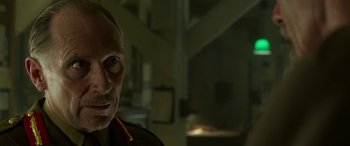 Movie still from “Churchill” (2017), directed by Jonathan Teplitzky – An older man wearing glasses and a military uniform; Close Up shot, Low angle