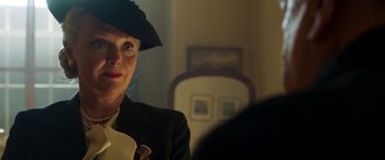 Movie still from “Churchill” (2017), directed by Jonathan Teplitzky – A woman wearing a black hat and a black suit; Close Up shot, Low angle