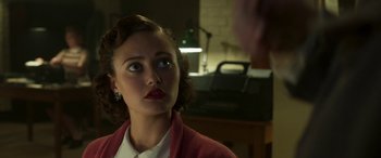 Movie still from “Churchill” (2017), directed by Jonathan Teplitzky – A woman in a white shirt and a red jacket looking at a man in a white shirt; Close Up shot, Over the shoulder angle