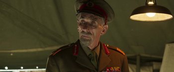 Movie still from “Churchill” (2017), directed by Jonathan Teplitzky – An older man in a military uniform looking to his left; Close Up shot, Low angle