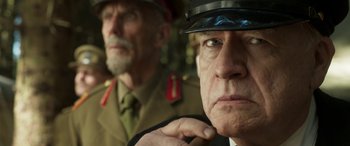 Movie still from “Churchill” (2017), directed by Jonathan Teplitzky – A man in a military uniform and a man in a suit and tie; Close Up shot, Low angle