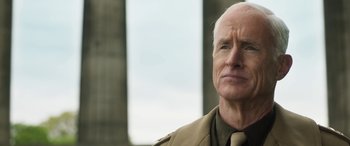 Movie still from “Churchill” (2017), directed by Jonathan Teplitzky – An older man in a tan jacket looking at the camera; Close Up shot, Low angle