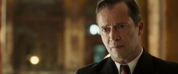 Movie still from “Churchill” (2017), directed by Jonathan Teplitzky – A person wearing a suit and tie; Close Up shot, Over the shoulder angle