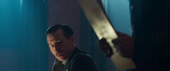 Movie still from “Churchill” (2017), directed by Jonathan Teplitzky – A man in a suit and tie holding a knife; Close Up shot, Over the shoulder angle