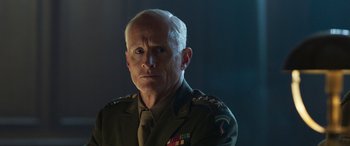 Movie still from “Churchill” (2017), directed by Jonathan Teplitzky – An older man in a military uniform is looking at the camera; Close Up shot, Over the shoulder angle