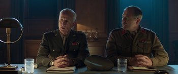 Movie still from “Churchill” (2017), directed by Jonathan Teplitzky – Two men sitting at a table in front of each other; Medium shot, Low angle