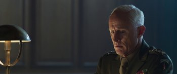 Movie still from “Churchill” (2017), directed by Jonathan Teplitzky – An older man wearing a uniform looking at the camera; Close Up shot, Over the shoulder angle